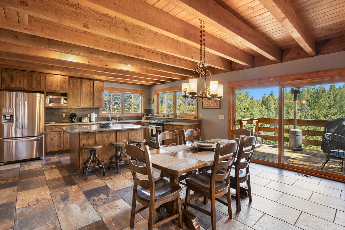 Gourmet kitchen and dining opening to the deck